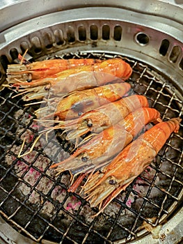 Grilling prawn on charcoal stove