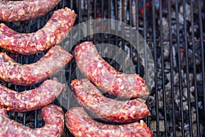 Grilling sausages and pork chops on barbecue grill. BBQ in the garden