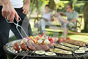 Grilling sausages and vegetables