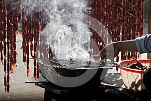 Grilling skewer sausage in mekong delta