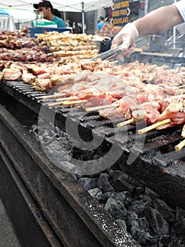 Grilling Skewers On A Charcoal BBQ, New York City Street Fair, NYC, NY, USA