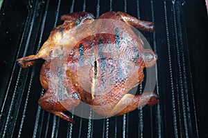 Grilling and smoking spatchcock chicken outdoors