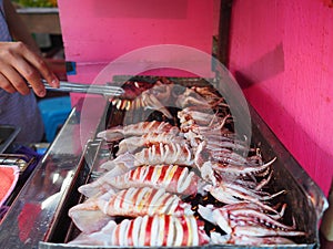 Grilling squids for sale in the market