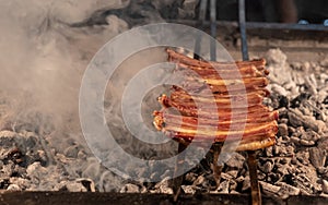 Grilling steaks on flaming grill and shot with selective focus