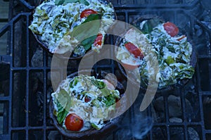 Grilling stuffed Portobello mushrooms on outdoor grill