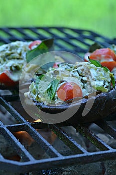 Grilling stuffed Portobello mushrooms on outdoor grill