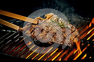 Grilling a tasty tender t-bone steak on the fire photo