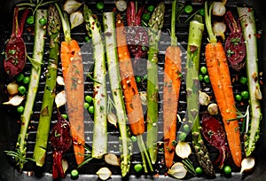 Grilling vegetables, raw vegetables prepared for grilling with the addition of olive oil, herbs and spices located on the grill pl