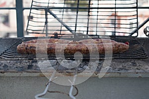 Grilling wursts on barbecue grill. Grilled meat sausages