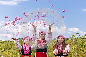 Grils throwing roses in the air