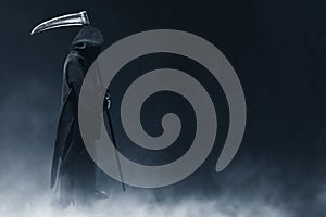 Grim reaper on dark backgrounds photo
