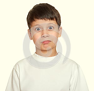 Grimacing face boy portrait, teenager closeup