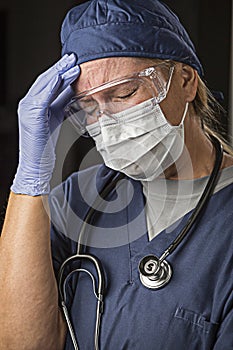 Grimacing Female Doctor or Nurse Wearing Protective Wear