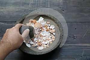 Grind egg shells in a mortar