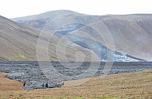 A unique natural attraction. People are walking over the new lavafield of the volcano eruption photo