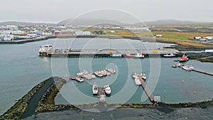 Grindavik, small fishing town, fishing boats docked on the pier on a cloudy autumn day