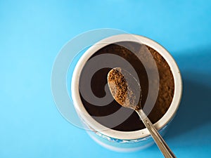 Grinded coffee on blue background