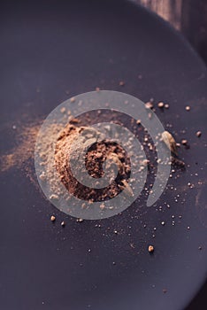 Grinded steak spices on a wooden table