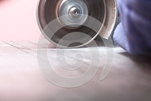 Grinder worker cuts a stone the electric tool