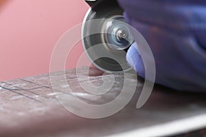 Grinder worker cuts a stone the electric tool