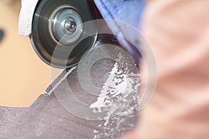 Grinder worker cuts a stone the electric tool