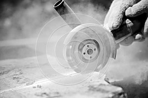 Grinder worker cuts a stone