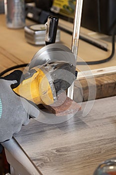Grinder worker cuts a stone the electric tool worker is tiling at home
