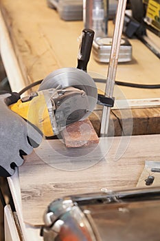 Grinder worker cuts a stone the electric tool worker is tiling at home