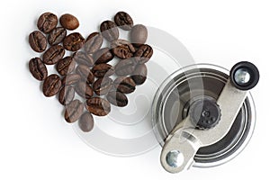 Grinding coffee beans in a manual coffee grinder on isolate white background