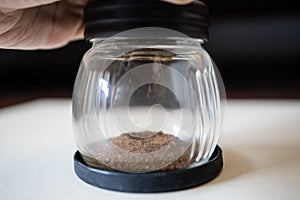Grinding coffee beans with manual grinder
