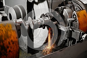 Grinding of the crankshaft on a grinding machine. Car tuning, engine power amplification. photo