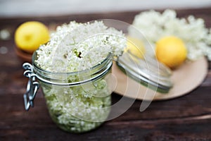 Grinding lemon and black elderberry on a cutting board to make an herbal drink or medicine for healing at home from