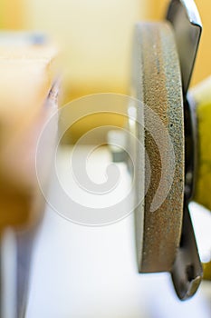 grinding machine with abrasive wheel close-up, selective focus