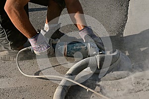 Grinding rough edges of concrete on a curb and road