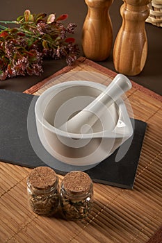 Grinding spices herbs in a mortar with pestle