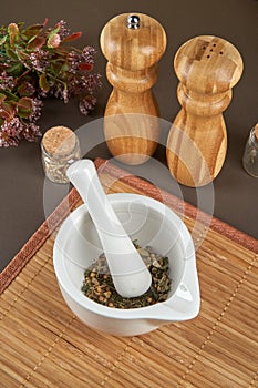 Grinding spices herbs in a mortar with pestle