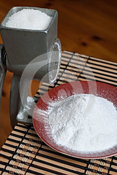 Grinding of sugar to the powder.