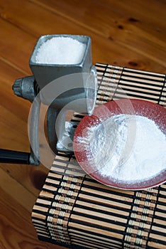 Grinding of sugar to the powder.