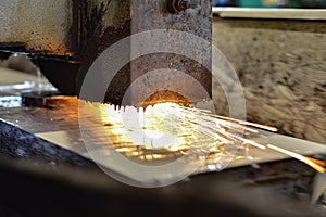 Grinding on a surface grinder. The part is mounted on a magnetic plate, a diamond-coated abrasive wheel is used for roughing