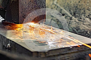 Grinding on a surface grinder. The part is mounted on a magnetic plate, a diamond-coated abrasive wheel is used for roughing