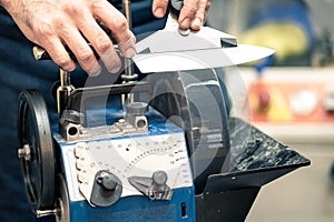 Grindstone close-up. Electric knife sharpening machine