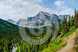 0000300_The Grinnell Glacier Trail opens up high above the ground as a storm develops. Mount Gould and Angel Wing are in clear