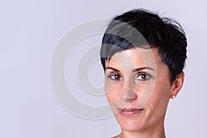 Grinning adult woman over neutral background