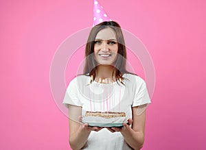 Grinning beauty holding cake isolated