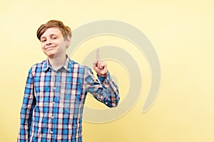 Grinning boy pointing to object or text, template