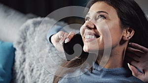 Grinning brunette talking phone close-up