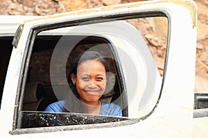 Grinning girl in car window