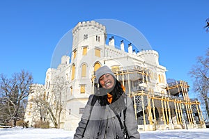 Grinning girl in front of palace Hluboka with terrace