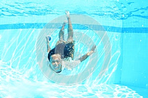 Grinning Papuan woman swimming in pool