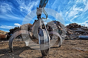 Gripper excavator on a scrap yard.